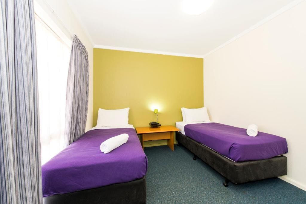 Standard Room with One Queen Bed and Two Single Beds room - Image 1
