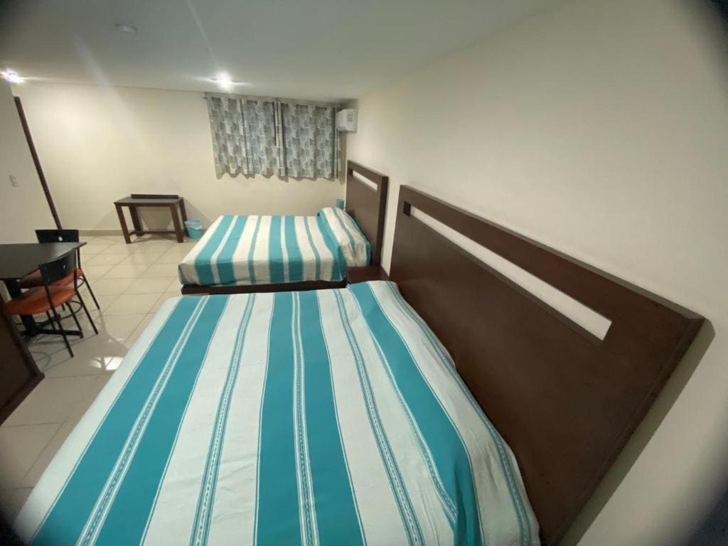 Deluxe Queen Room with Two Queen Beds room - Image 1