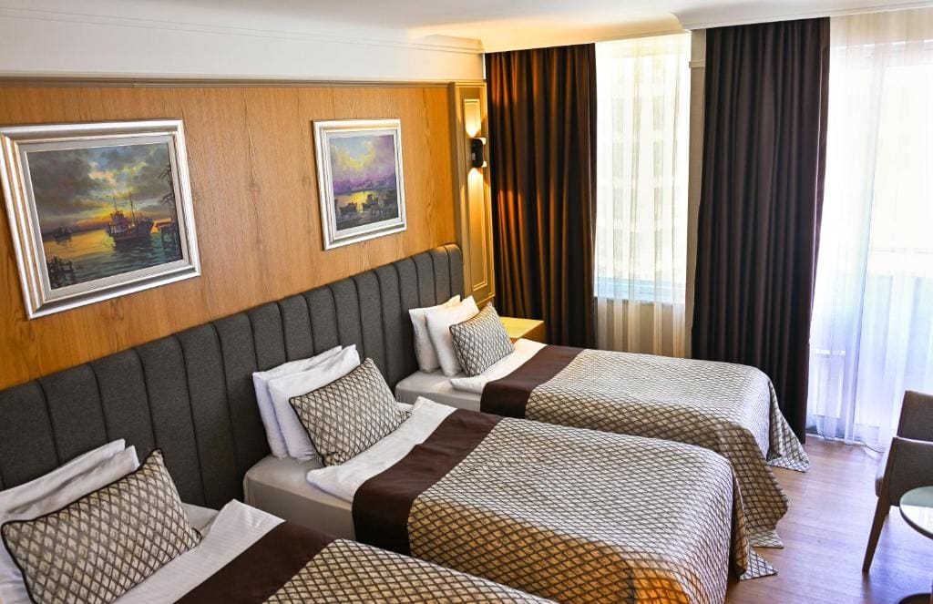 Standard Triple Room with Side Sea View room - Image 1