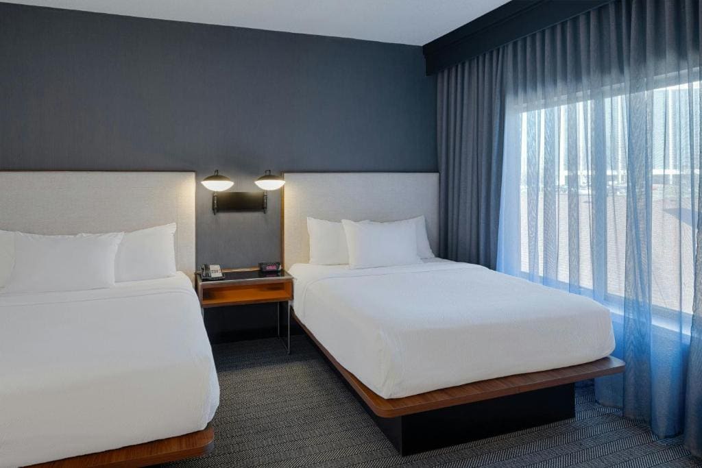 One-Bedroom Queen Suite with Two Queen Beds and Sofa Bed room - Image 1