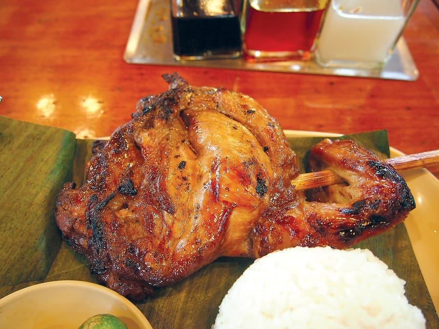 Chicken inasal skewered and basted with annatto oil over open coals at Manokan Country.
