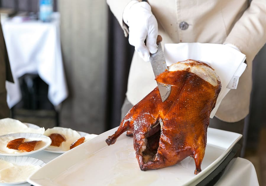 Crispy Peking duck carved tableside, served with thin wheat pancakes, scallions, and sweet bean sauce.