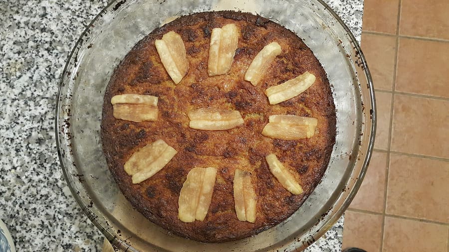 Babka ziemniaczana served with cream and lard toppings.