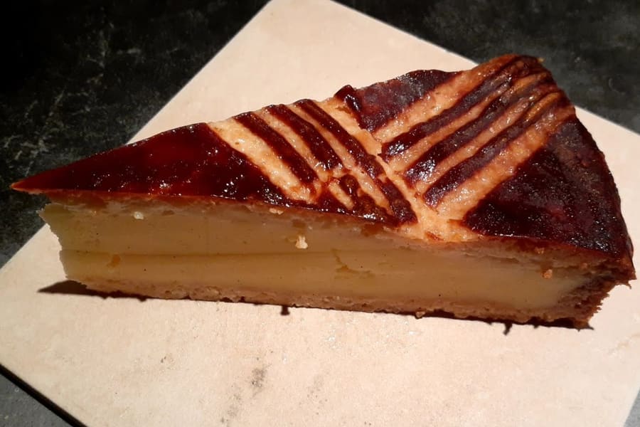 Gâteau Basque served with black cherry jam or pastry cream.