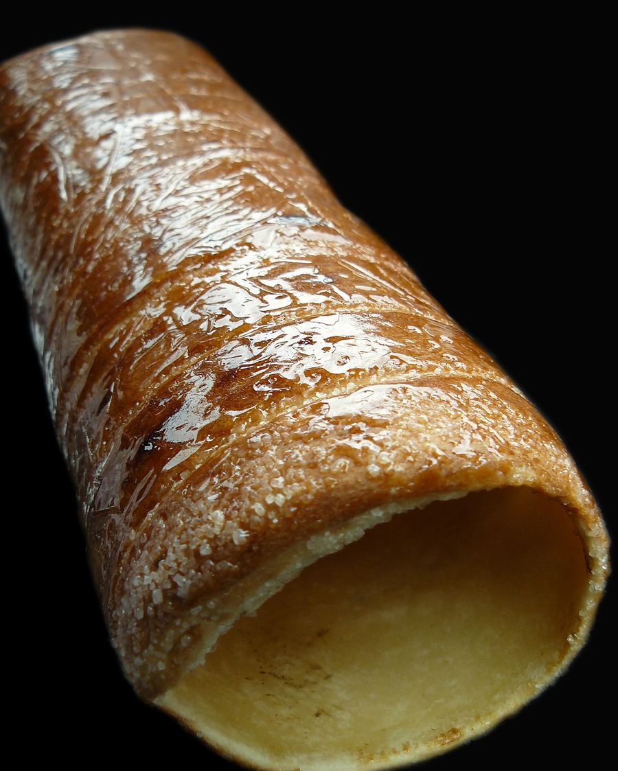 Kürtőskalács baked freshly over hot coals at a street stand near Strada Republicii.