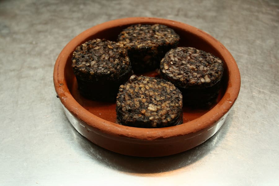 Morcilla de Burgos served sliced and pan-fried with roasted red peppers.