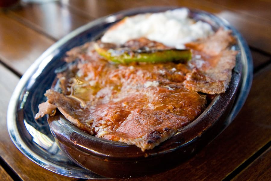 Freshly melted sheep-milk butter poured over Iskender kebap at a traditional Bursa lokanta.