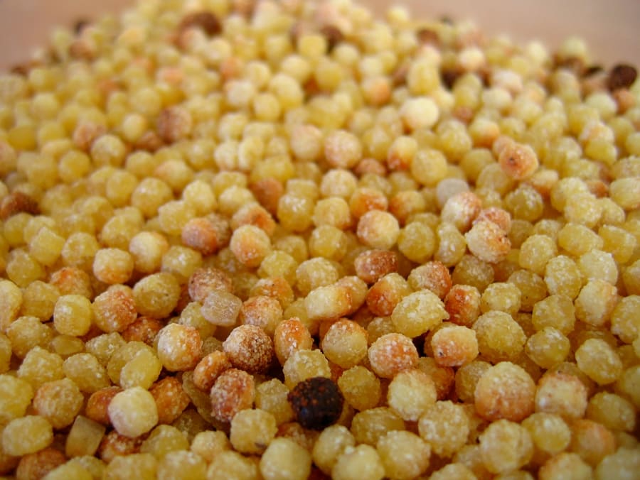 Fregula con arselle served in a traditional broth.