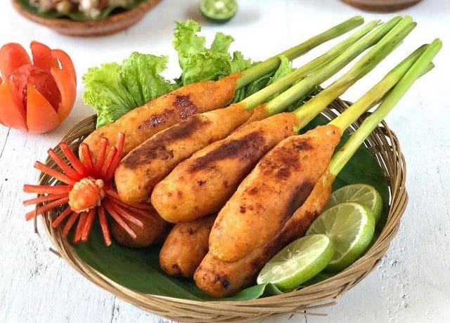 Sate lilit fish skewers grilled over coconut charcoal at a roadside warung.