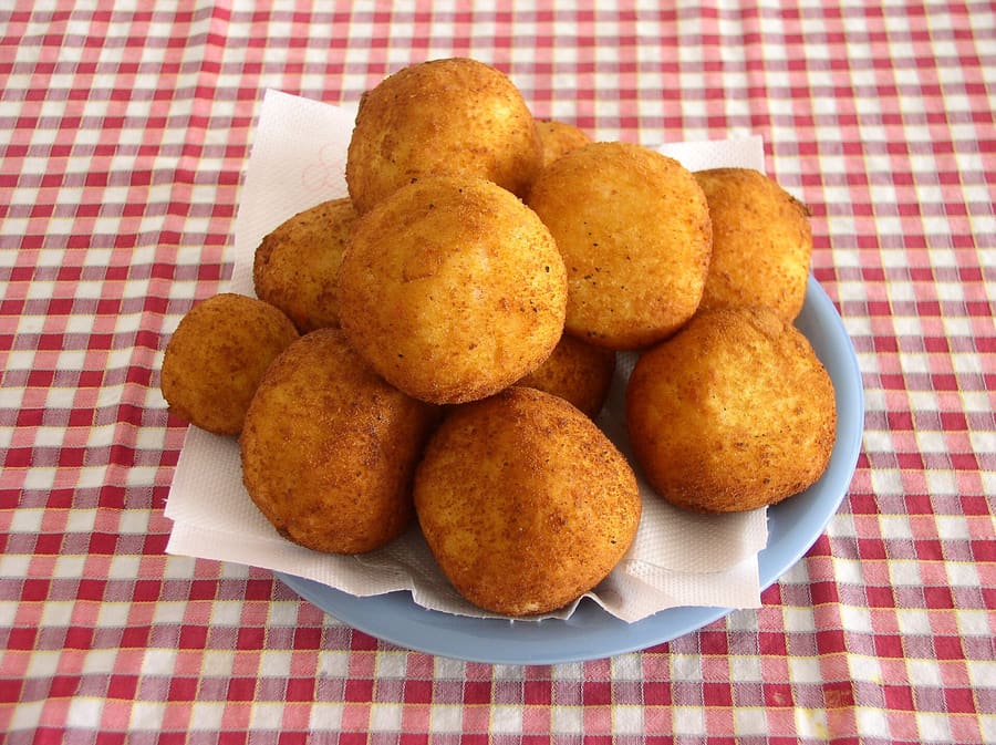 A pointed Catanian arancino filled with ragù, peas, and caciocavallo cheese.