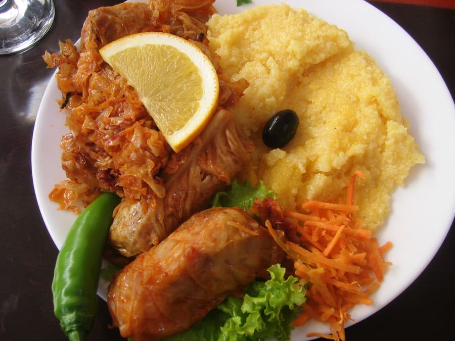 Freshly pan-fried plăcintă pastries cut into quarters.