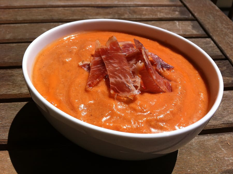 Freshly dressed salmorejo topped with cured ham and diced egg.