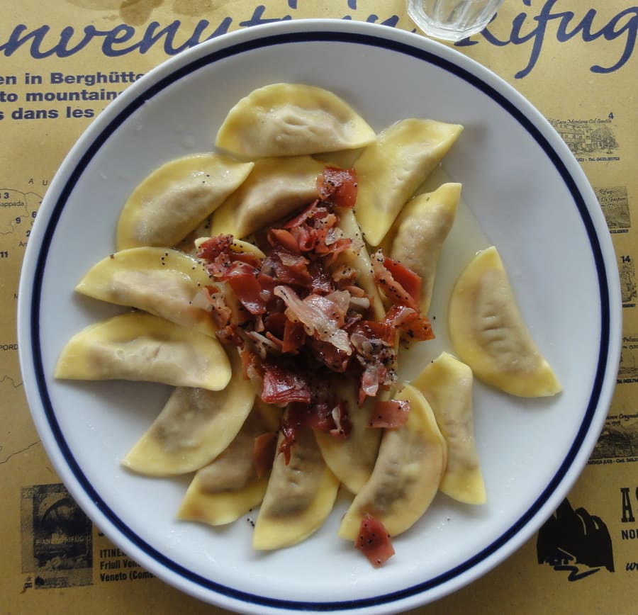 Casunziei all'ampezzana topped with melted butter and poppy seeds.