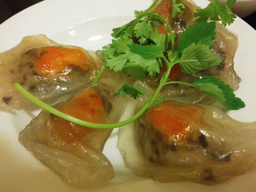 Banh bot loc filled with shrimp and pork, steamed inside banana leaves.