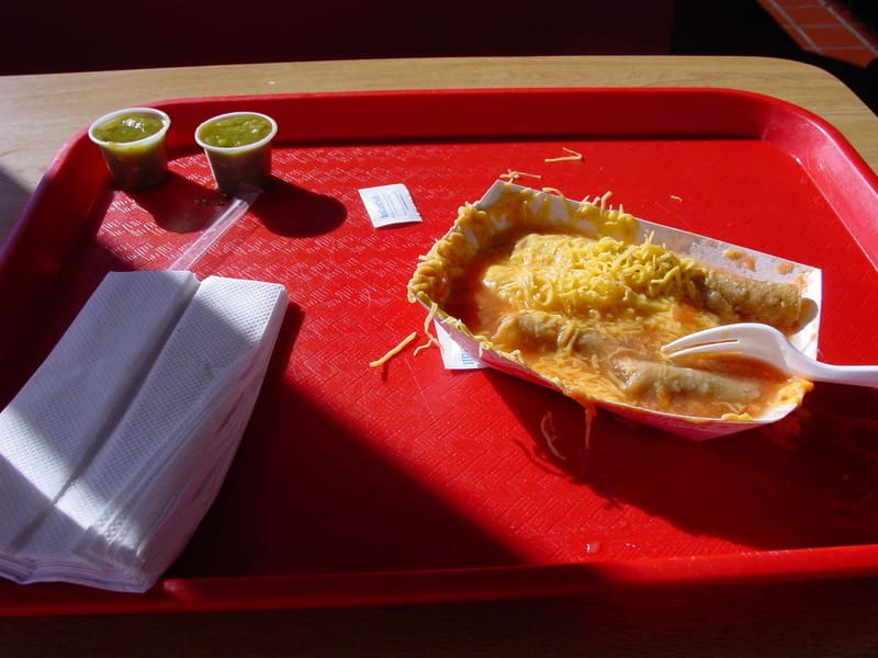 Rolled tacos served floating in tomato broth at a local staple.
