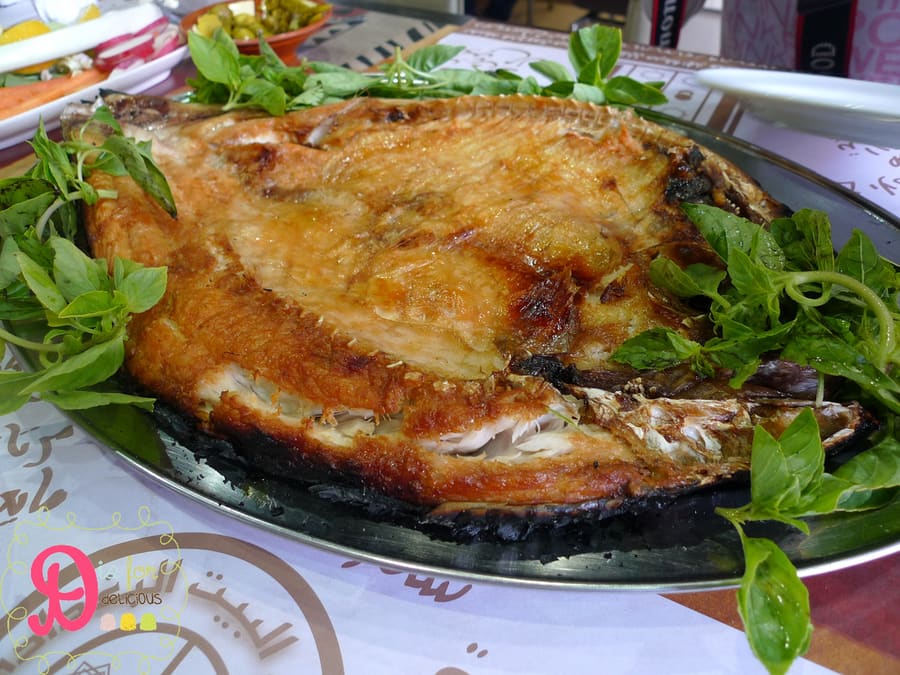 Fresh carp butterfly-cut and slow-roasted over open embers for masgouf.