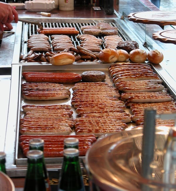 Thüringer Rostbratwurst grilled over open charcoal on Domplatz.