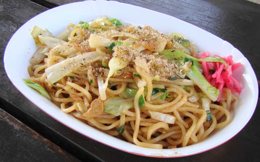Fujinomiya yakisoba cooked on a steel griddle and dusted with ground sardine powder.
