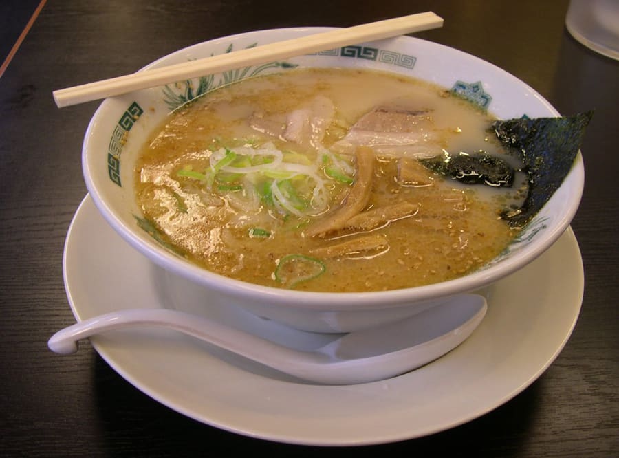 A bowl of Hakata tonkotsu ramen served with thin straight noodles and sliced pork chashu.