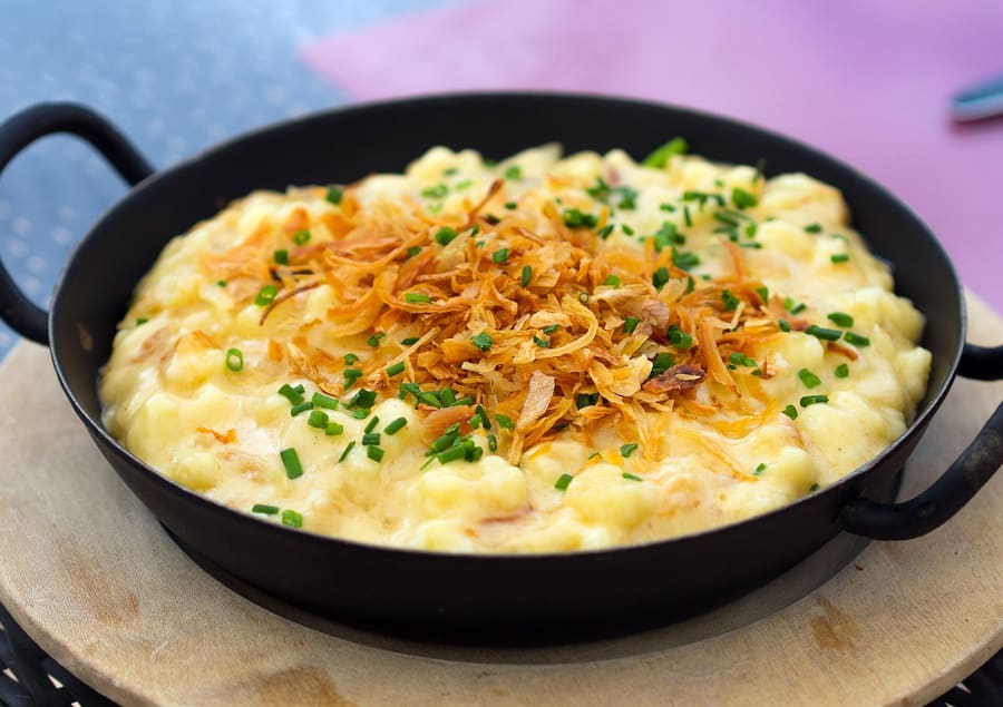 Allgäuer Kässpätzle baked with local Bergkäse and topped with dark onions.
