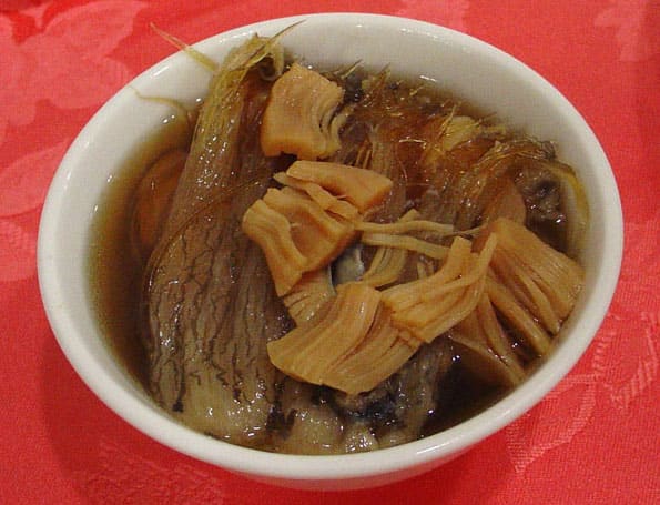 A clay crock of Buddha Jumps Over the Wall soup simmered with Shaoxing wine.