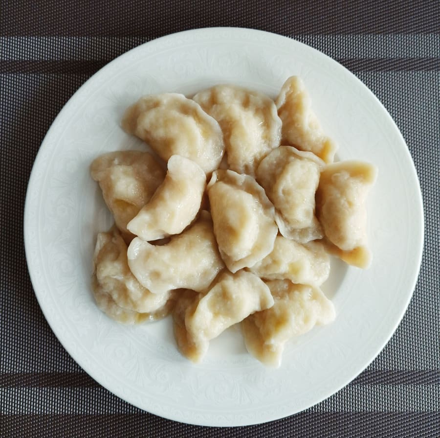 Traditional pan-fried pierogi served with caramelized onions.