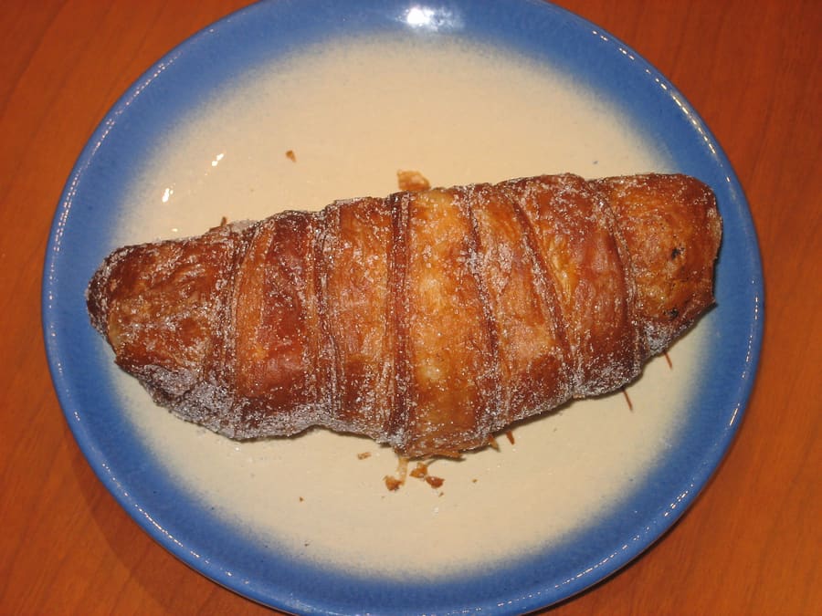 A fresh xuixo pastry filled with custard crema catalana.