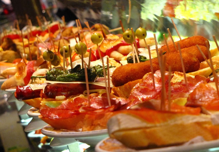 Tapas served alongside draft beer in central Granada.