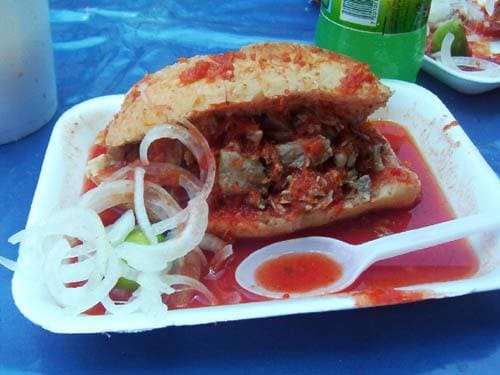 A classic torta ahogada served drenched in spiced tomato sauce.