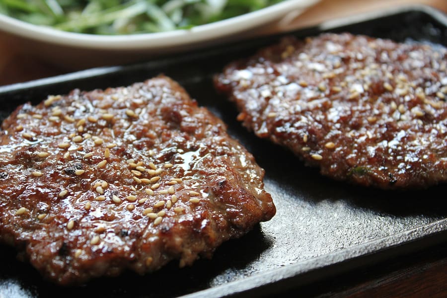 Songjeong Tteokgalbi: grilled minced pork rib patties served alongside complimentary gamja-tang broth.