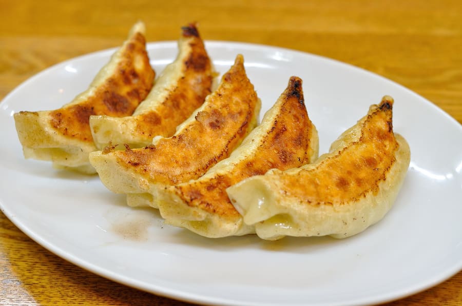 Crispy Hamamatsu gyoza served in traditional circular formation with boiled bean sprouts.