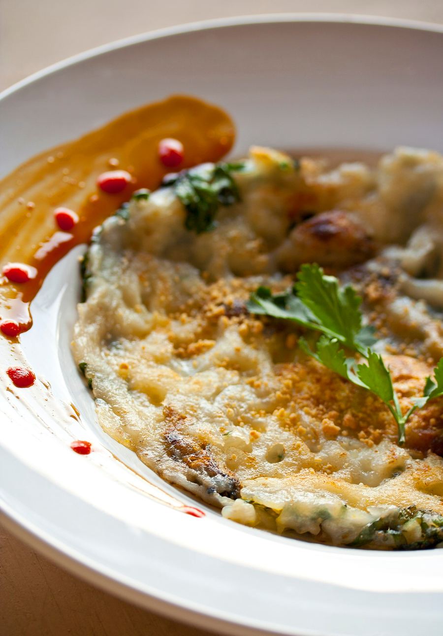 Crispy oyster omelette served on a hot metal platter at Hua Hin Night Market.