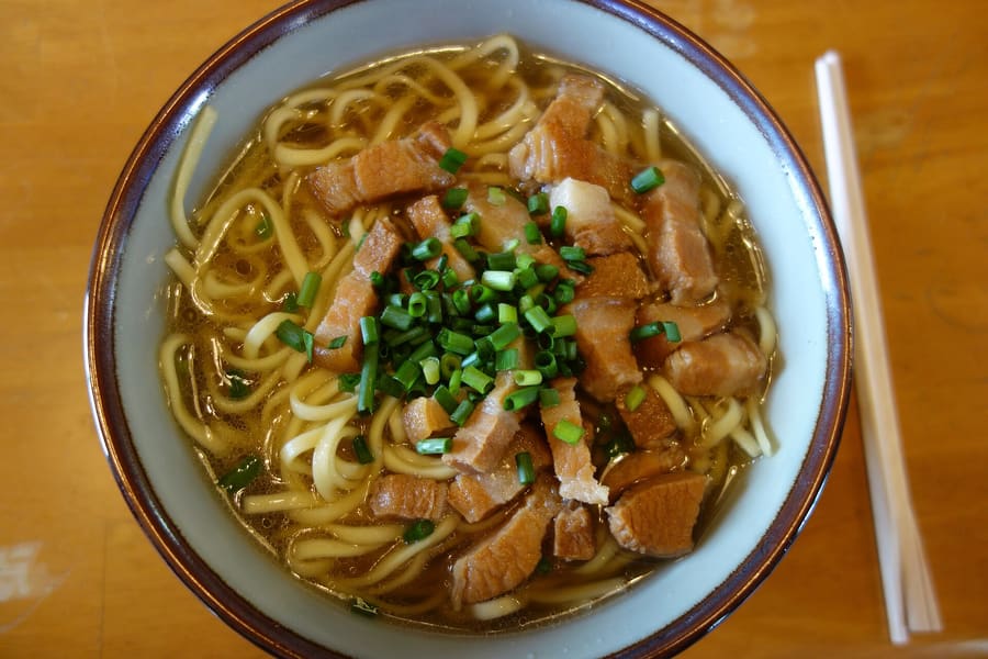 Yaeyama soba topped with shredded pork belly and island fishcake.