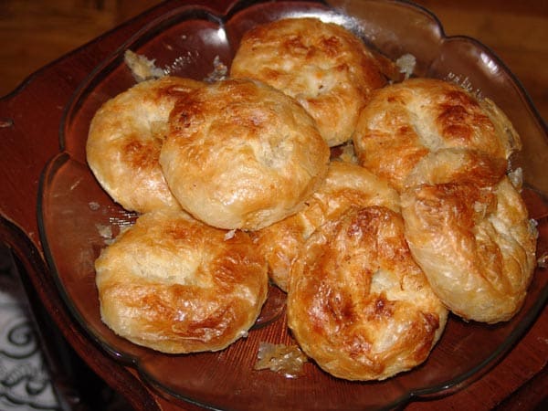 A classic Izmir breakfast: flaky baked boyoz served hot alongside a roasted hard-boiled egg.