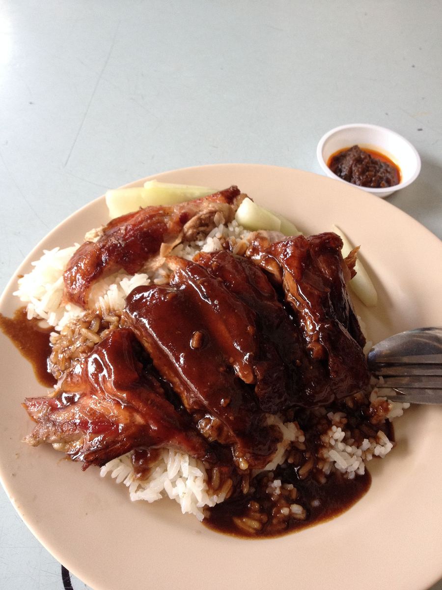Duck rice served with poached duck slices and savoury pork oil in Yancheng.