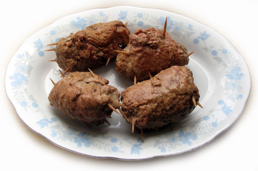Rolada śląska served with kluski dumplings and braised red cabbage.