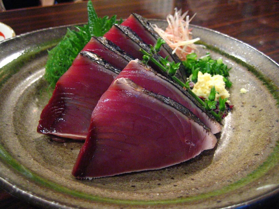 Katsuo no Tataki, seared over burning rice straw and served with raw garlic and sea salt.