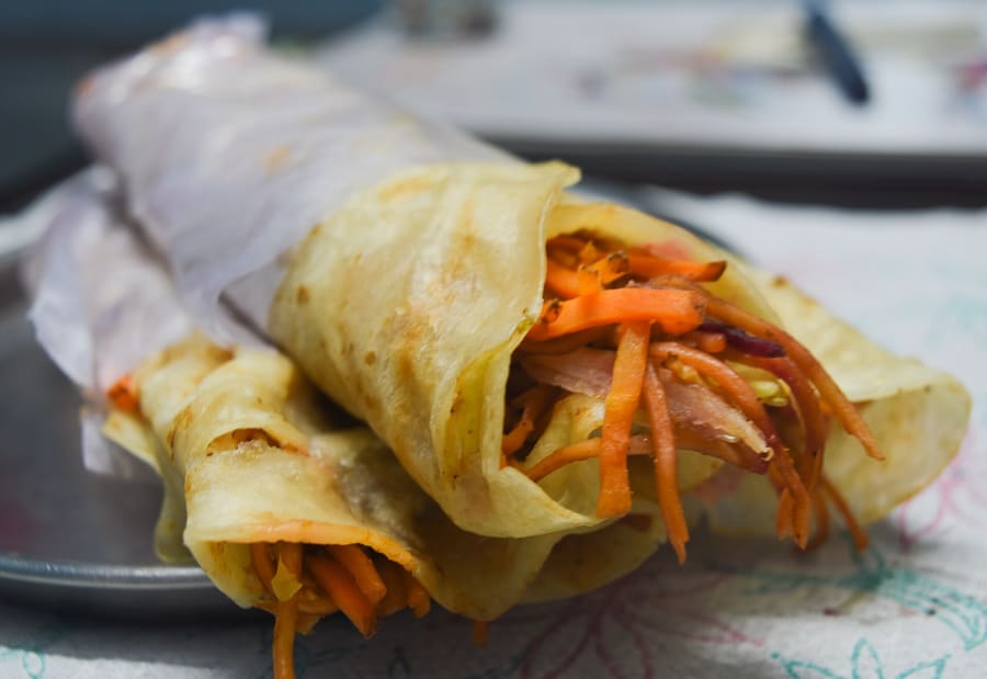 Freshly assembled mutton kati rolls wrapped in crisp parathas.