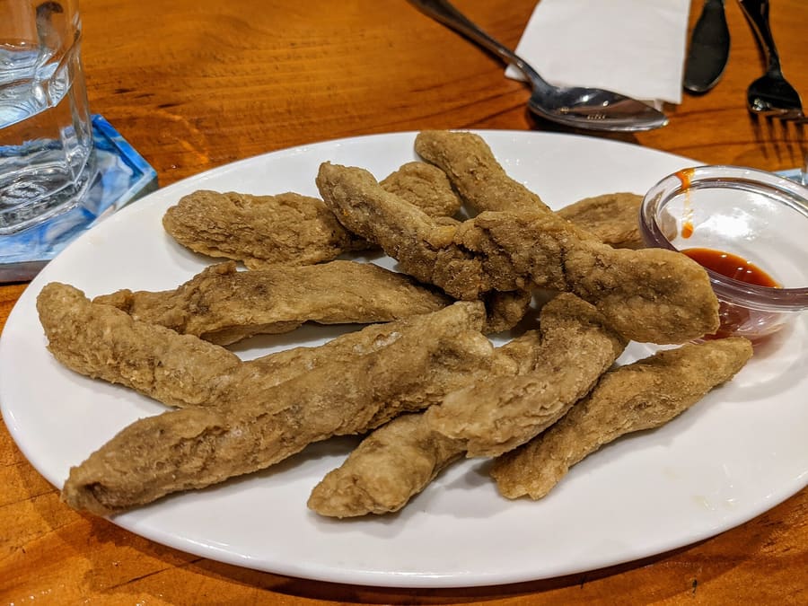 Freshly fried keropok lekor served hot with local chilli sauce.
