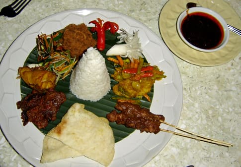 Spicy Balinese nasi campur served with sambal and braised meats.