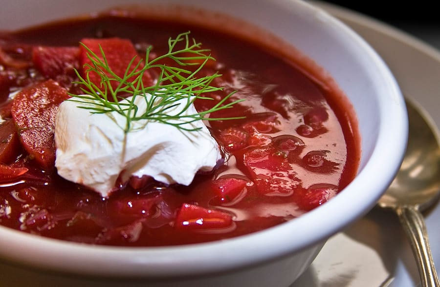 Traditional Ukrainian borscht served with garlic pampushky rolls.
