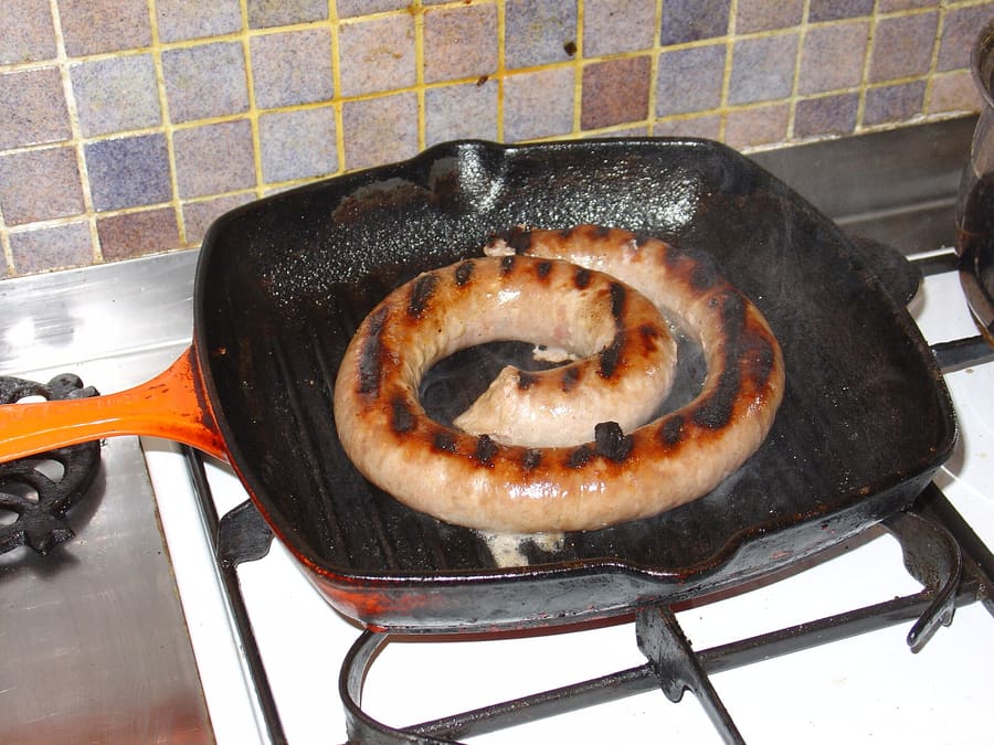 Traditional coiled Cumberland sausage served with onion gravy.