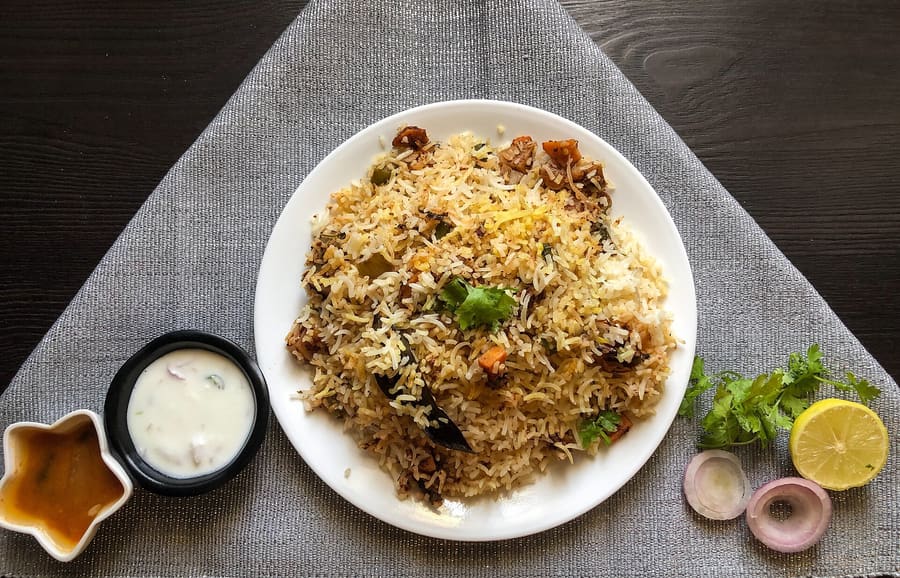 Khao Mok Gai (Thai chicken biryani) served with turmeric rice and sweet chili sauce.