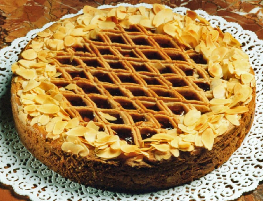 A slice of classic Linzer Torte with its distinctive lattice crust and redcurrant filling.