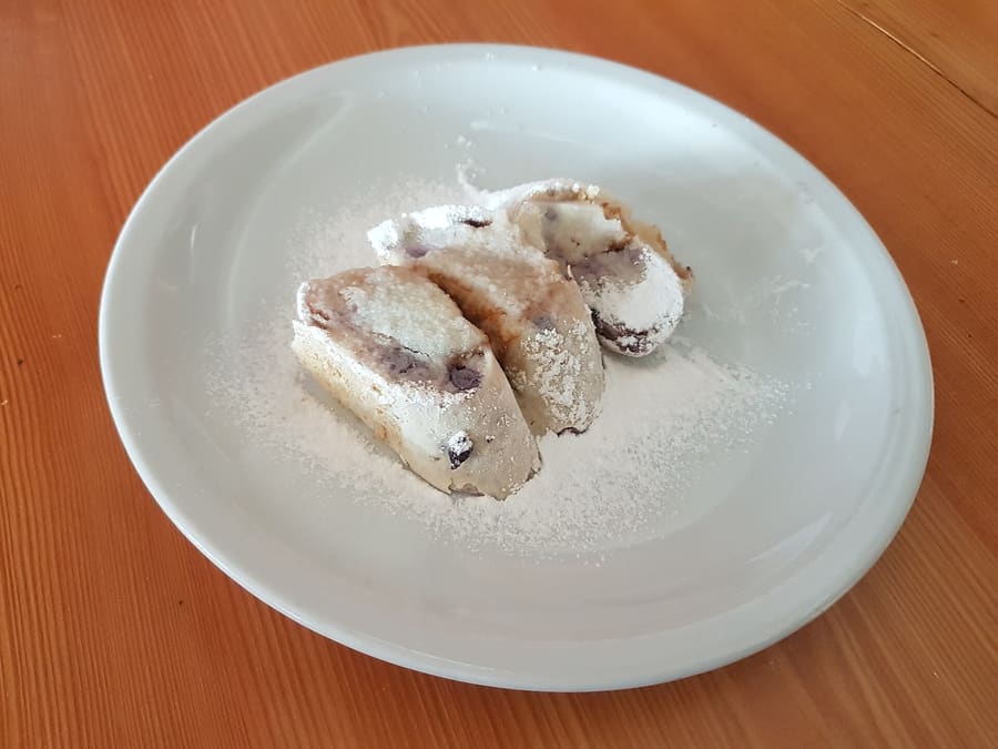 Traditional rolled štruklji dough dumplings filled with cottage cheese, tarragon, or walnuts.