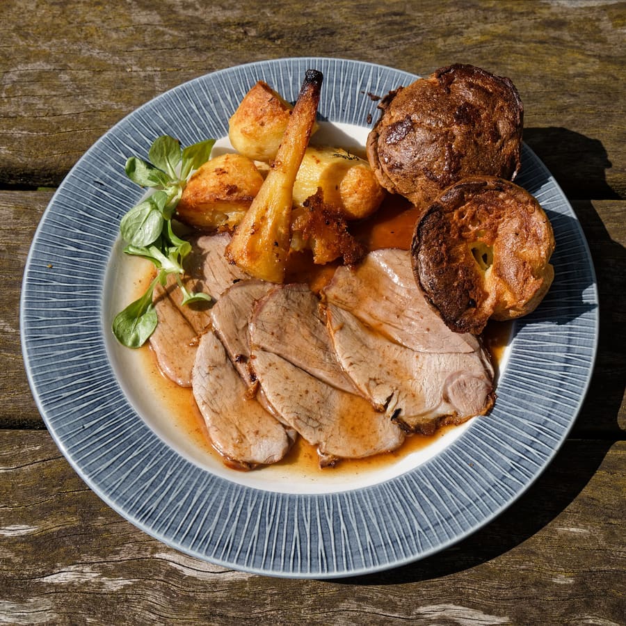 A traditional pub Sunday roast, complete with Yorkshire pudding and roasted vegetables.