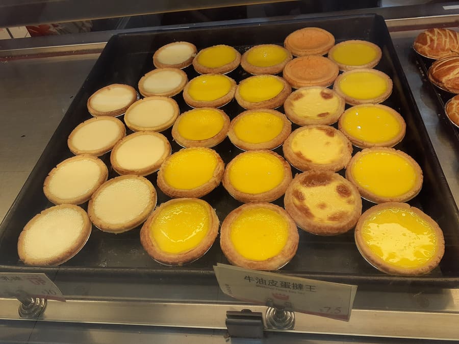 Freshly baked Portuguese egg tarts served straight from the oven.