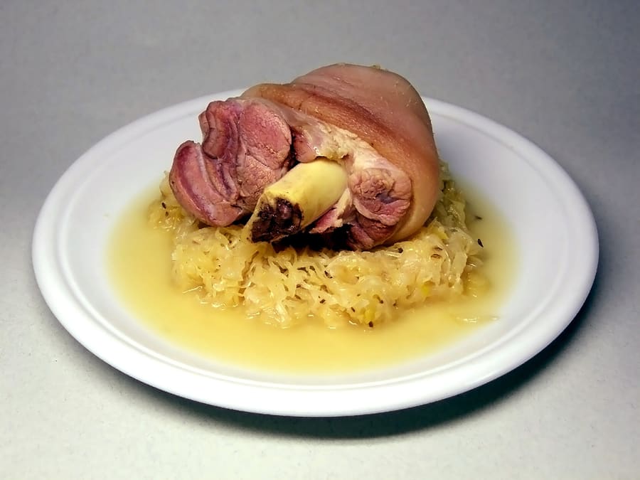 Magdeburger Bötel served with pea puree and sauerkraut.