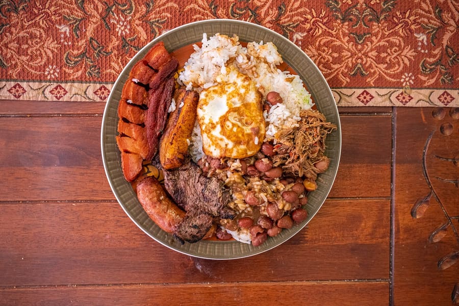 A traditional Bandeja Paisa served in a clay dish.