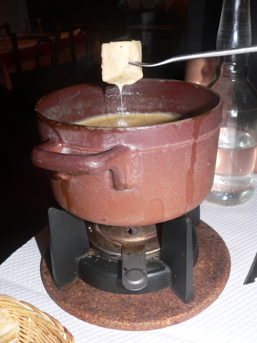 Fondue Savoyarde served with local cheeses and cured ham.